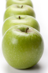 row of green apples