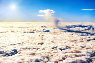 Blue sky, shining sun and clouds