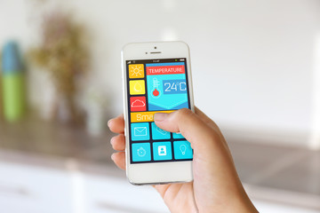 Fototapeta na wymiar Using smart home app on phone. Smart home control concept.