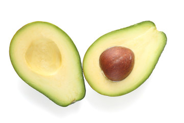 Halves of fresh avocado isolated on white