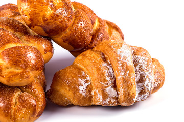pile of fresh and delicious kroissants and rolls on a white back