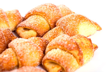 pile of fresh and delicious kroissants and rolls on a white back