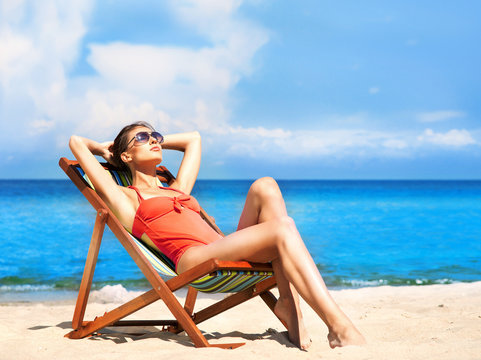 Young And Sexy Woman In A Deckchair On The Beach