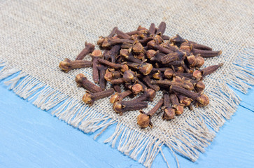 Cloves on a blue board.