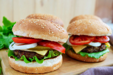 Sandwich homemade hamburger with juicy burgers, cheese,  fresh vegetables