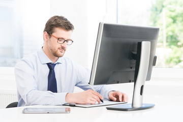 Young and confident businessman working in a modern office