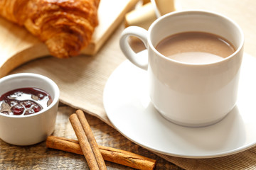 Breakfast with coffee and croissants on wooden table