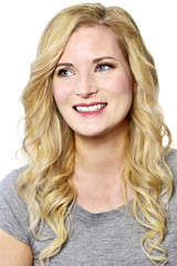 Naklejka premium Beautiful blond woman smiling. Positive Emotions. Young woman with copy space, isolated on white background.