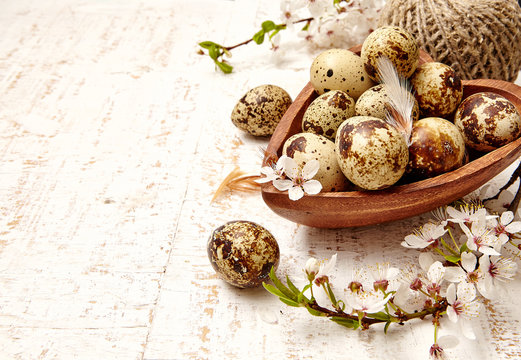 Spring easter composition with eggs and cherry flowers on a whiteold wooden  background 