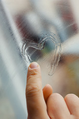 Heart drawn on the fogged glass window