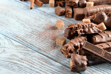 Chocolate sweets with powder on wooden background