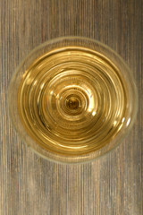 Glass of wine on wooden table. Top view