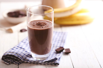 Glass of chocolate milk on table close-up