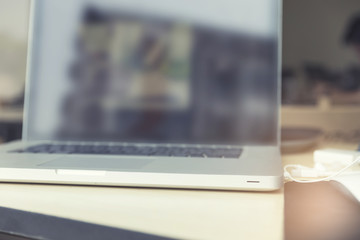 earphone and laptop computer notebook on wooden table, vintage t
