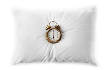 Alarm clock on pillow, isolated on white