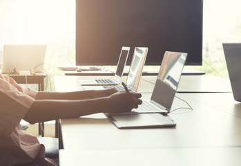 man' hand holding pen working on digital graphic tablet and comp