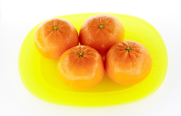 Tangerines on yellow plate