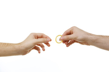 One man giving a condom to another man isolated on white