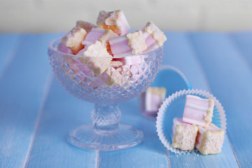 Tasty marshmallows with chocolate in bowl on table, close up