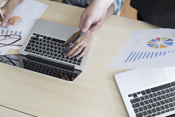 men working with business document and computer notebook