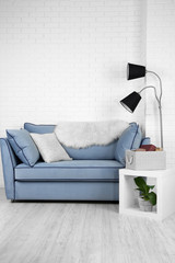 Beautiful modern living room with blue sofa and floor lamp