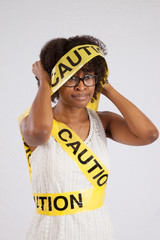 Lovely Black woman wrapped in Yellow Caution Tape