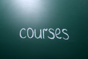 Courses inscription written with white chalk on blackboard