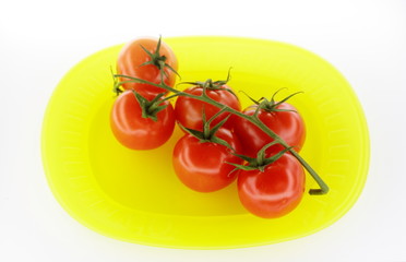 Tomatoes on yellow plate