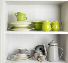 Tableware on shelves in the kitchen cupboard