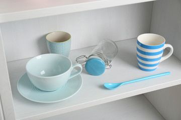 Tableware on shelf in the kitchen cupboard