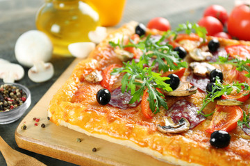 Rectangle delicious pizza and vegetables on the table, close-up