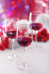 Wineglasses on red blurred lights background