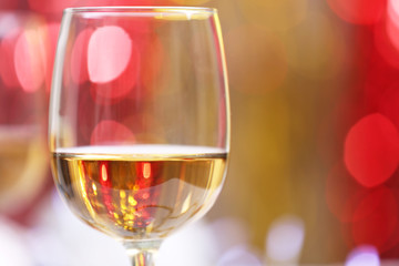 Wineglass on blurred lights background
