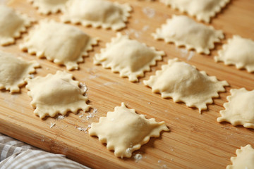 Uncooked ravioli on cutting board