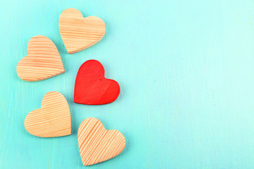 Wooden hearts on color wooden background