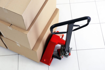 Manual pallet truck with carton boxes indoors