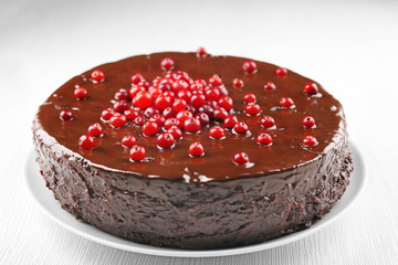 Chocolate cake with cranberries on plate, closeup