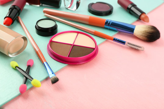 Makeup set with brushes and cosmetics on bright background