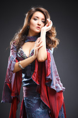 Naklejka premium Beautiful belly dancer young woman in gorgeous dress