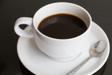 Obraz na płótnie Canvas espreso black coffee in white cup on black table