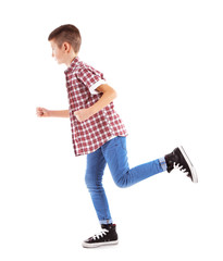 Naklejka premium Little boy running left, isolated on white