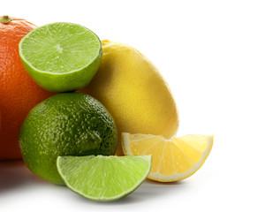 Fototapeta na wymiar Mixed citrus fruit including lemons, orange and limes isolated on a white background, close up