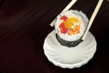 sushi with chopsticks.