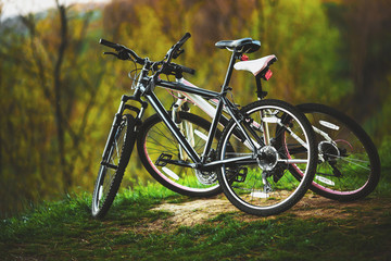Fototapeta na wymiar Biking. A romantic walk. Two bikes are at the top of the hill