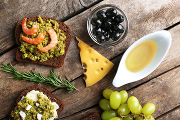 Avocado sandwiches with vegetables on dark wooden background