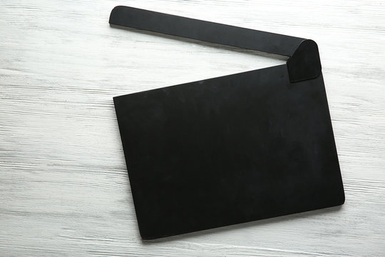 Movie clapperboard on wooden background