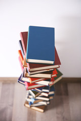 Pile of books on wall background
