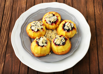 Plate of cakes on wooden background