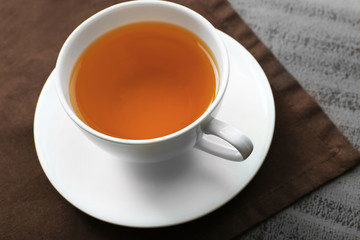 Cup of tea on brown napkin