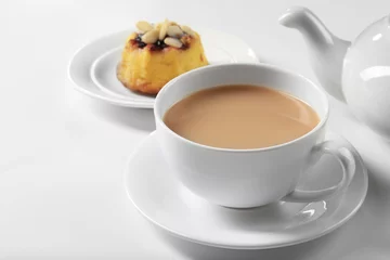 Papier Peint photo autocollant Theé Milk tea with tea pot and a dessert on white background